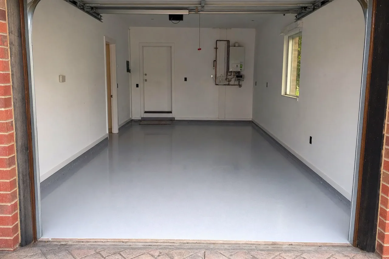 A clean coated grey garage floor seen from the open door — epoxy flooring, Bendigo. Illustrative example.